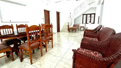 a dining room with a table and chairs at Pavans Rainy Days Home Stay in Athirappilly