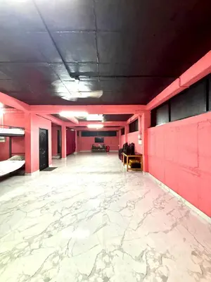 an empty room with pink walls and a white floor at Pavans Rainy Days Home Stay in Athirappilly