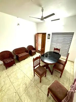 a living room with a table and chairs at Pavans Rainy Days Home Stay in Athirappilly