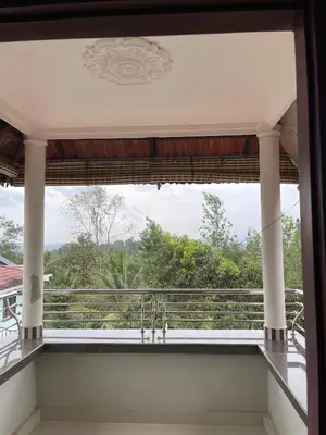 a view from the balcony of a house at Wayanad Midnight Farmhouse in Sultan Bathery