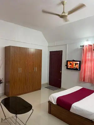 a bedroom with a bed and a ceiling fan at Wayanad Midnight Farmhouse in Sultan Bathery