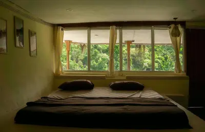 a bed with two pillows in a bedroom with a window at Nirvana 'By the lake' in Kūkkāl