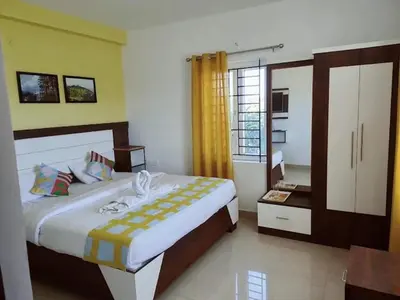 a bedroom with a large bed and a window at Hill Grove By Brown Tree Resorts in Ooty