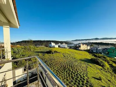 a view of a beach from a balcony of a house at Hill Grove By Brown Tree Resorts in Ooty