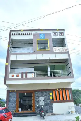 a building with a motorcycle parked in front of it at CS RESORT River point in Wodapatti
