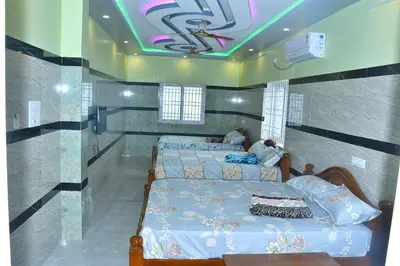 a bedroom with two beds and a ceiling with at CS RESORT River point in Wodapatti