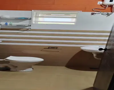 a bathroom with a toilet and a sink at Kadavath Homestay in Ernakulam