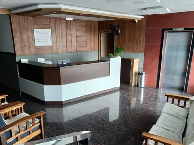 a lobby with a reception desk in a building at SUROOR Recidency in Virajpet