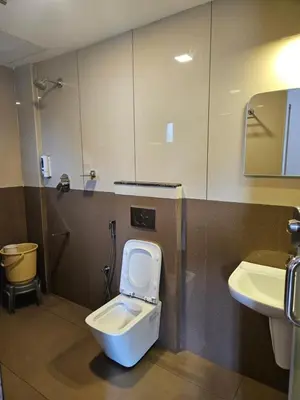 a bathroom with a toilet and a sink at SUROOR Recidency in Virajpet