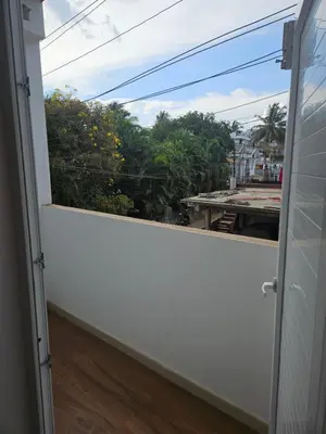 a view from a balcony with a window at SUROOR Recidency in Virajpet
