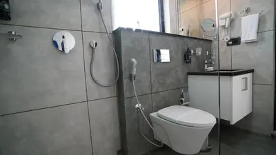 a bathroom with a toilet and a shower at Manjoora Saddles Resorts & Spa in Padinjarathara