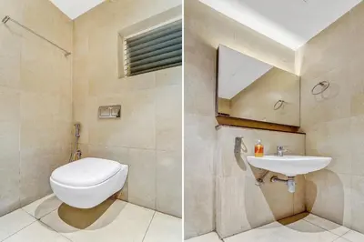 a bathroom with a toilet and a sink at Hotel Karpagam Lodging House Nr Railway Station & Gandhipuram bus stand in Coimbatore