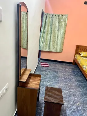 a room with a mirror and a bed at Athithi AC Studio Flat By Shivalaya Stays in Podanūr