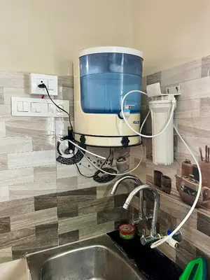 a kitchen sink with a large appliance on the wall at Athithi AC Studio Flat By Shivalaya Stays in Podanūr