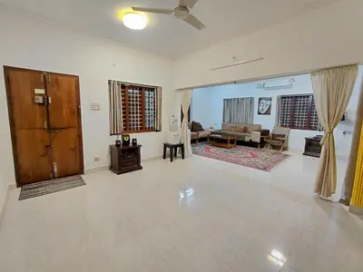a living room with a couch and a table at Guruvayur Agraharam Homestay in Guruvāyūr