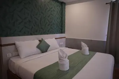 a bedroom with a bed with white towels on it at Shola Heaven Resort in Kanthalloor