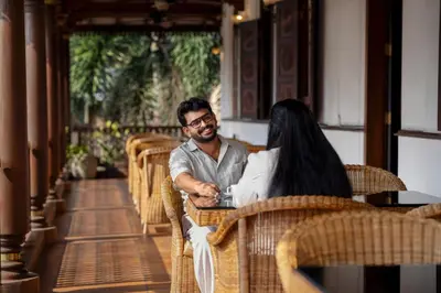 a man and a woman sitting at a table at Villa de 1945 in Mahe