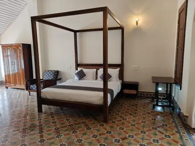 a bedroom with a canopy bed in a room at The Estate Bay by Z Vacations in Gonikoppal