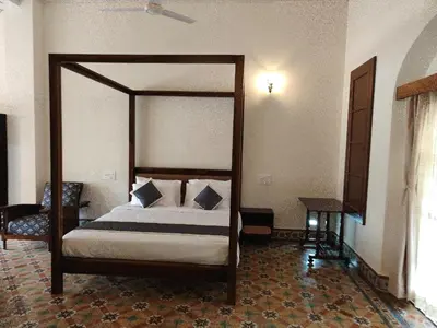 a bedroom with a canopy bed in a room at The Estate Bay by Z Vacations in Gonikoppal