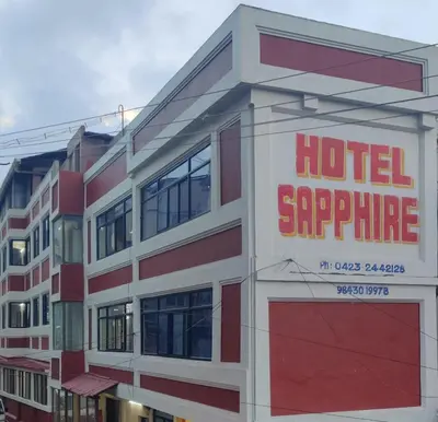 a hotel supreme sign on the side of a building at Hotelsapphire in Ooty