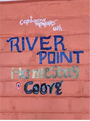 a wall with the words river point houston cove painted on it at River point homestay in Kushālnagar