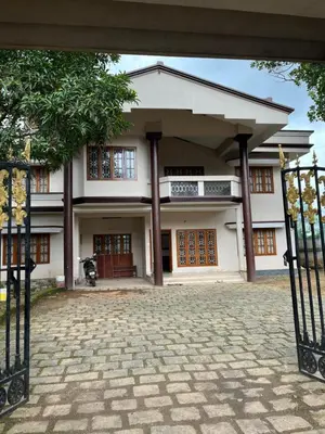 a house with a gate in front of it at Dragster Homes Alwaye in Alwaye
