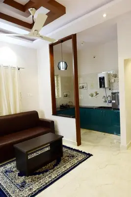 a living room with a couch and a mirror at PuMi Residence in Vānivilāsa Puram