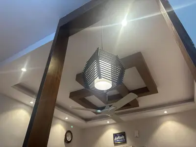 a chandelier hanging from a ceiling in a room at PuMi Residence in Vānivilāsa Puram