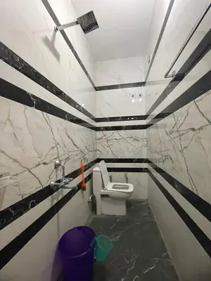 a bathroom with a white toilet in a room at LunaBloom Stays in Marayoor