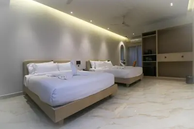 a hotel room with two beds with white sheets at Hotel Shellmark in Elivāla