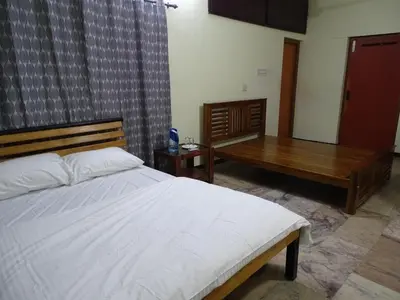 a bedroom with a bed and a wooden table at Eden luxury stay saravanampatti in Coimbatore