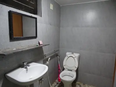 a bathroom with a sink and a toilet and a mirror at Eden luxury stay saravanampatti in Coimbatore