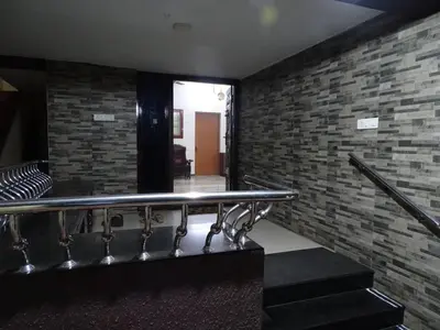 a staircase in a building with a brick wall at Eden luxury stay saravanampatti in Coimbatore