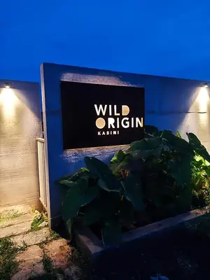 a sign on the side of a building at Wild Origin Kabini - A Luxury Resort in Kabini River