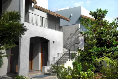 a white house with stairs and a door at Wild Origin Kabini - A Luxury Resort in Kabini River