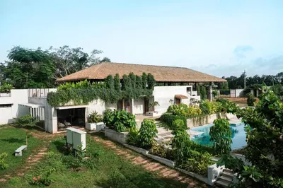 a house with a swimming pool in front of it at Wild Origin Kabini - A Luxury Resort in Kabini River