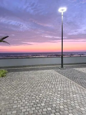 a street light on a sidewalk near the beach at Seawind in Kannur