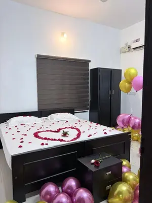a bedroom with balloons and a bed with a heart on it at Seawind in Kannur