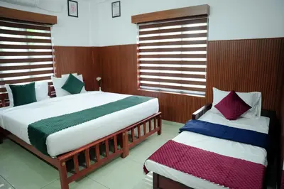 two beds in a bedroom with wooden walls and windows at TREE 9 COCHIN AiRPORT HOTEL in Nedumbassery