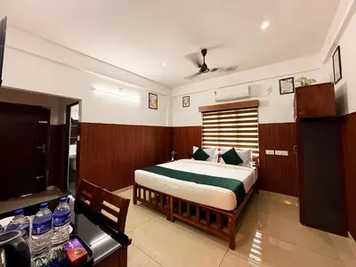a bedroom with a bed and a television in it at TREE 9 COCHIN AiRPORT HOTEL in Nedumbassery
