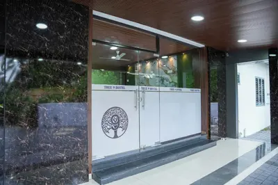 a store front with a white door in a building at TREE 9 COCHIN AiRPORT HOTEL in Nedumbassery