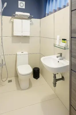 a bathroom with a toilet and a sink at The Nest in Trichūr