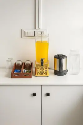 a glass of orange juice sitting on top of a counter at The Nest in Trichūr