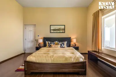 a bedroom with a bed and a window at StayVista at Farview Presidential Suite with Lawn, Bonfire & Bathtub in Kotagiri