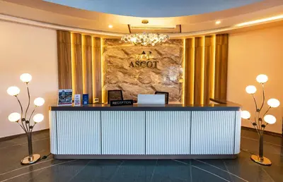 a reception desk in a hotel lobby at Ascot Hotel Calicut in Calicut