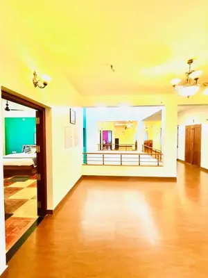 a large living room with a couch and a bed at WAYANAD RESORT VILLA Service in Meppādi