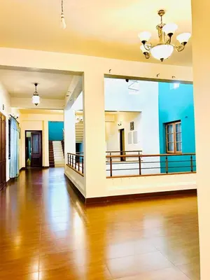 a living room with a wooden floor and a chandelier at WAYANAD RESORT VILLA Service in Meppādi