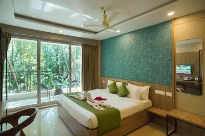 a bedroom with a large bed and a large window at Sreepathi Prayag 11 Service Apartment in Guruvāyūr