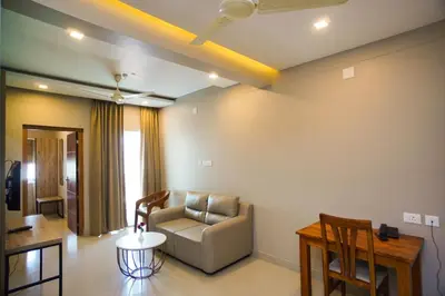 a living room with a couch and a table at Sreepathi Prayag 11 Service Apartment in Guruvāyūr