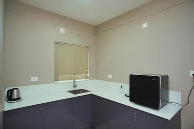 a kitchen with a sink and a tv on a counter at Sreepathi Prayag 11 Service Apartment in Guruvāyūr